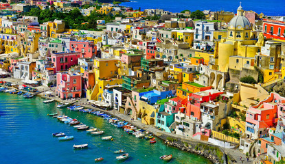 Fototapeta na wymiar View of the Port of Corricella with lots of colorful houses on a sunny day in Procida Island, Italy.