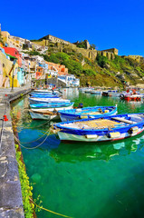 Fototapeta na wymiar View of the colorful houses at the Port of Corricella in Procida Island, Italy.