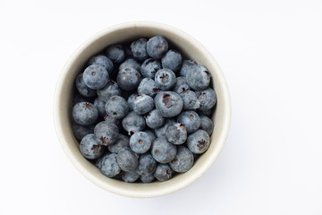 blueberries in a bowl isolated on white background