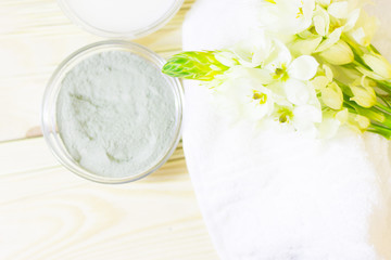Cucumber home spa and hair care concept. Sliced cucumber, bottles of oil, sea salt, bathroom towel. Straw light background
