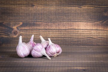 Garlic on a wooden Halloween background with copyspace