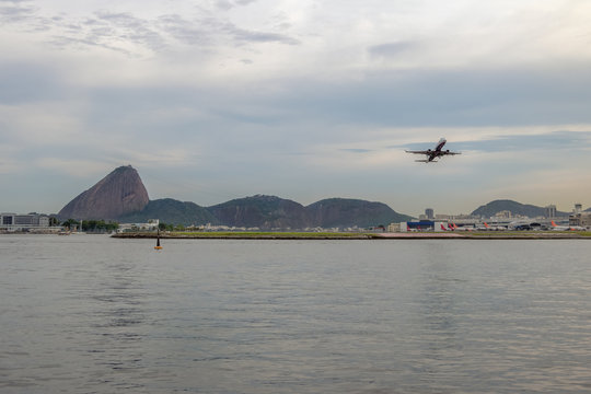 Plane Taking Off at Rio de Janeiro Airport with Sugar Loaf on background - Rio de Janeiro, Brazil