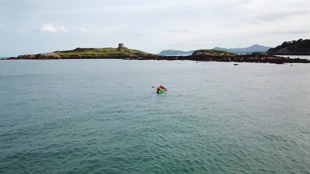 young couple kayaking in sea near the Dalkey Island in Dublin, Ireland.