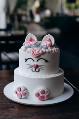 funny cake in the form of a cat in several tiers