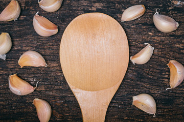 garlic asian herb ingredient on wooden table with wood spoon space for text