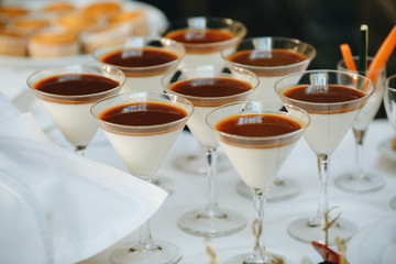Legged glasses and delicious Italian sweets are ready for a very tasty service
