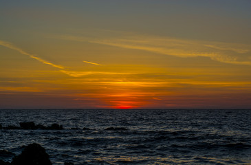 bright pink and orange sunset on the background of the sea in Corfu, Greece