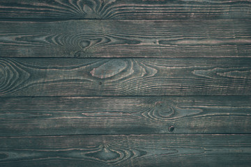 Background of wooden texture boards with remnants of dark paint. Horizontal.
