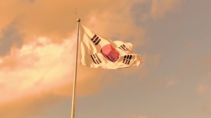 A cloud of dust passing behind a waving korean flag