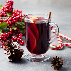 Mulled red wine with spices, orange slices. New year and Christmas background.