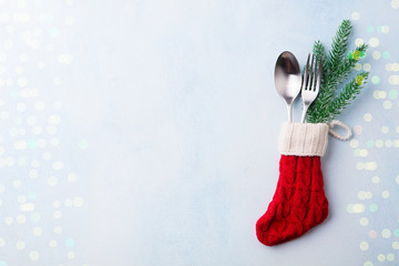 Christmas, New Year celebration place table setting. Knitted sock with cutlery and decoration. Copy...