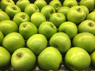 Juicy and smooth green apples in the store