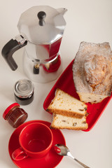 Breakfast - coffee and cupcake in a red bowl on a white background.