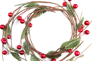 A top closeup view of  christmas  round twigs with leaves and red berries