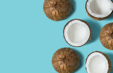 Top view of coconut isolated on blue background Summer concept. Flat lay. Pattern.