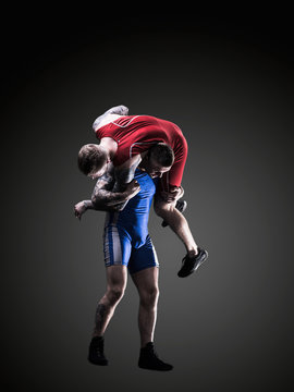 Two Wrestlers Figting Isolated On Black Back