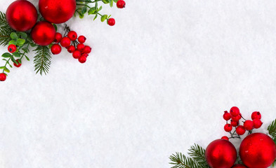 Christmas decoration. Frame of twigs christmas tree, christmas red balls and red berries on snow with space for text. Top view, flat lay