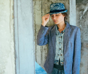 Portrait of a young woman in a hat and jacket. Street style