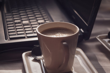 Business breakfast with coffee and laptop