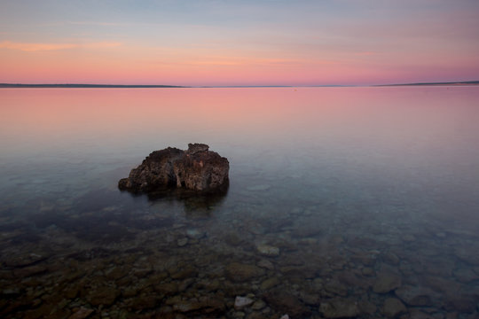 Croatian Sunset Beach with Rock in Foregrounf and Pastel Color Sky
