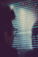 Hacker using computer, smartphone and coding to steal password and private data