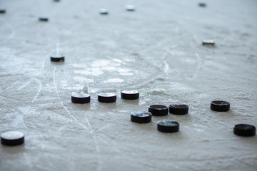 pucks on empty ice rink