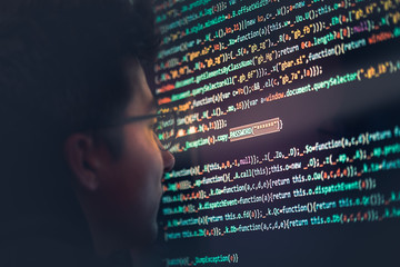 Hacker using computer, smartphone and coding to steal password and private data