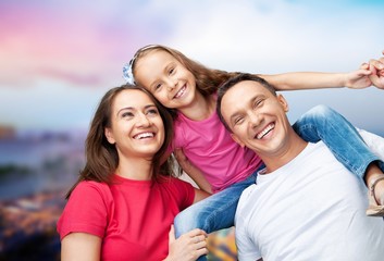 Happy cheerful young family on sky background