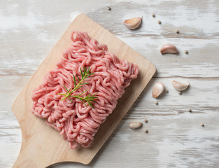 Raw minced pork uncooked with garlic pepper on the cutting board,Top view.