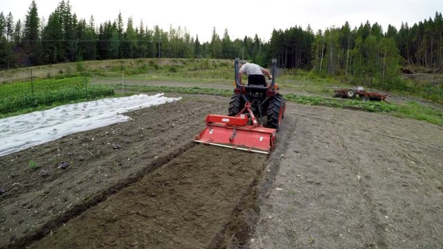 Man suing tractor in the farm 4k