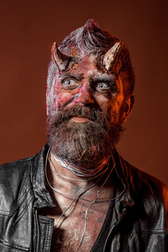 Halloween satan with beard, red blood, wounds on face