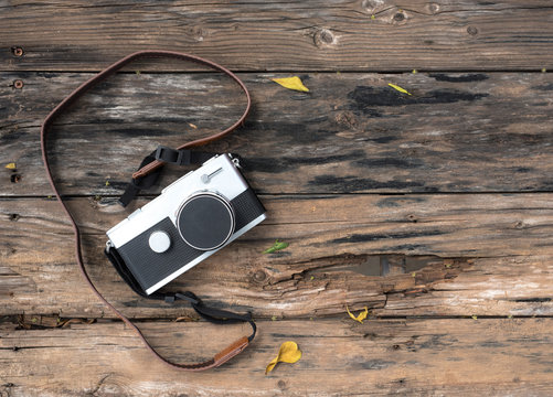 Old retro camera on a wooden background,Top view,Copy space