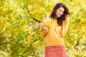 Autumn woman in autumn park. Warm sunny weather. Fall concept