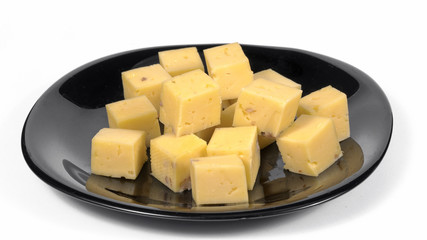 cheese cubes in a plate on a white background