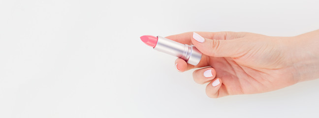 Woman hand with pink lipstick
