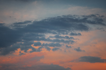 Obraz premium Colorful sunset sky with textures fluffy clouds and orange and blue color tones. Summer evening sunset light. Braunschweig, Germany