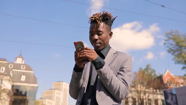 African amrican man in city communicating by video chat