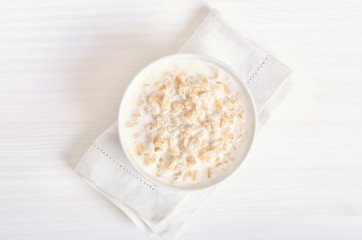 Oatmeal porridge in white bowl