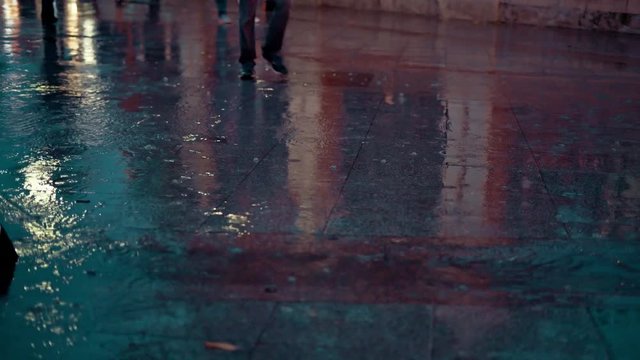 close up people walking in the city street during the heavy rain