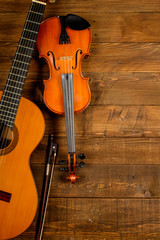 Fototapeta na wymiar guitar and violin in wood background