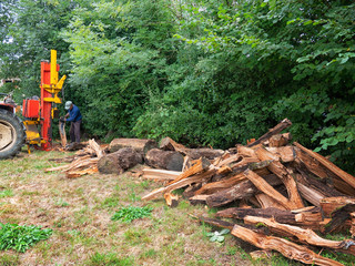 Fototapeta premium heap of split wood with log splitter