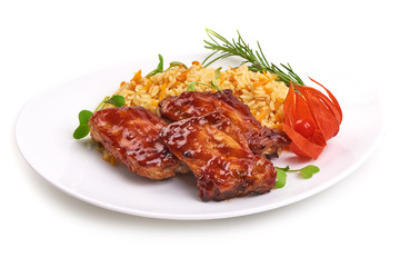 Delicious grilled pork ribs in BBQ sauce with pilaf on white plate, isolated on white background. Close-up