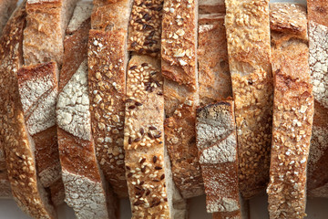 Macro photo of different pieces of fresh bread with flax seeds and sesame seeds. Healthy food. Flat...