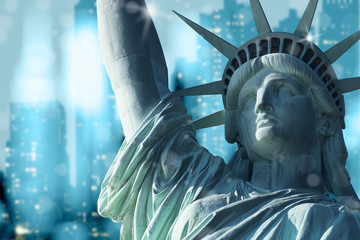 Close up statue of liberty with freezing blue tone bokeh of skyscrapers in background, Manhattan, New York, USA