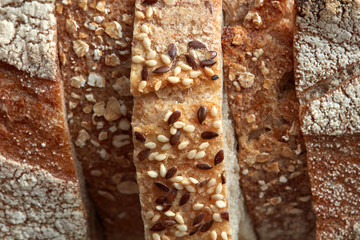 Crispy organic bread slices with flax seeds and sesame macro photo. Flat lay