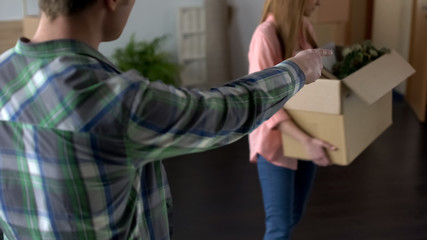 Angry man breaking up with girlfriend, unhappy woman leaving house, stuff in box