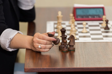 Woomen taking a piece in chess