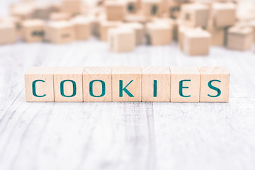 The Word Cookies Formed By Wooden Blocks On A White Table