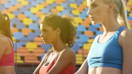 Beautiful ladies training at stadium, spirit of competition, multiracial team