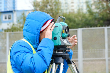 Civil engineer land survey with tacheometer or theodolite equipment. Worker Checking construction site on the road. Surveyor engineer making measuring with theodolite instrument level tool.
